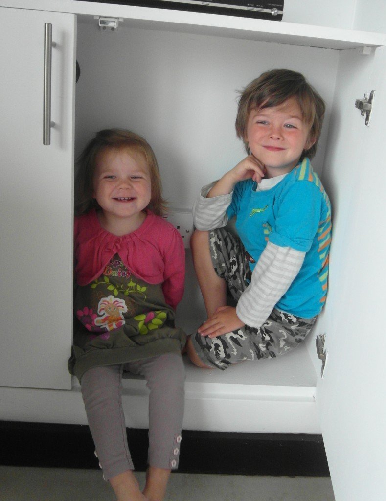 Two children in a cupboard