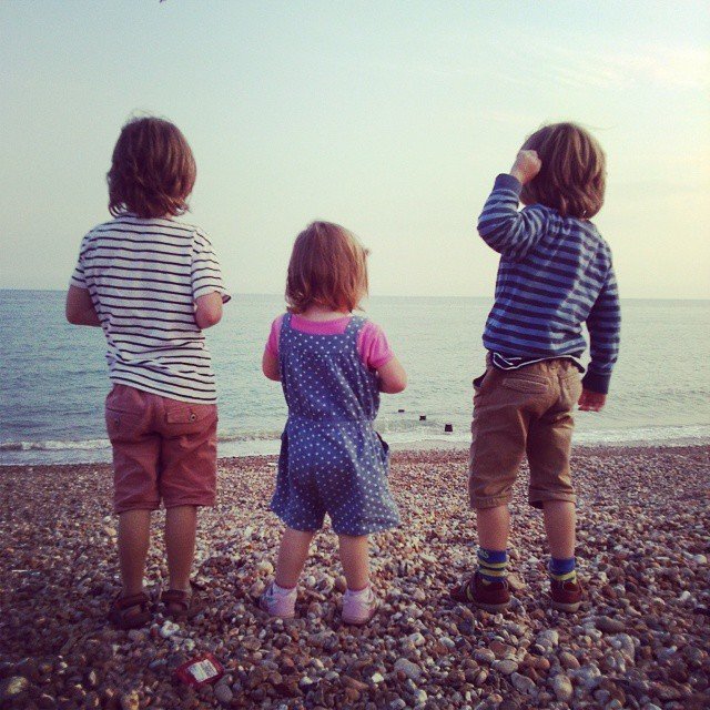 Three children on a beach