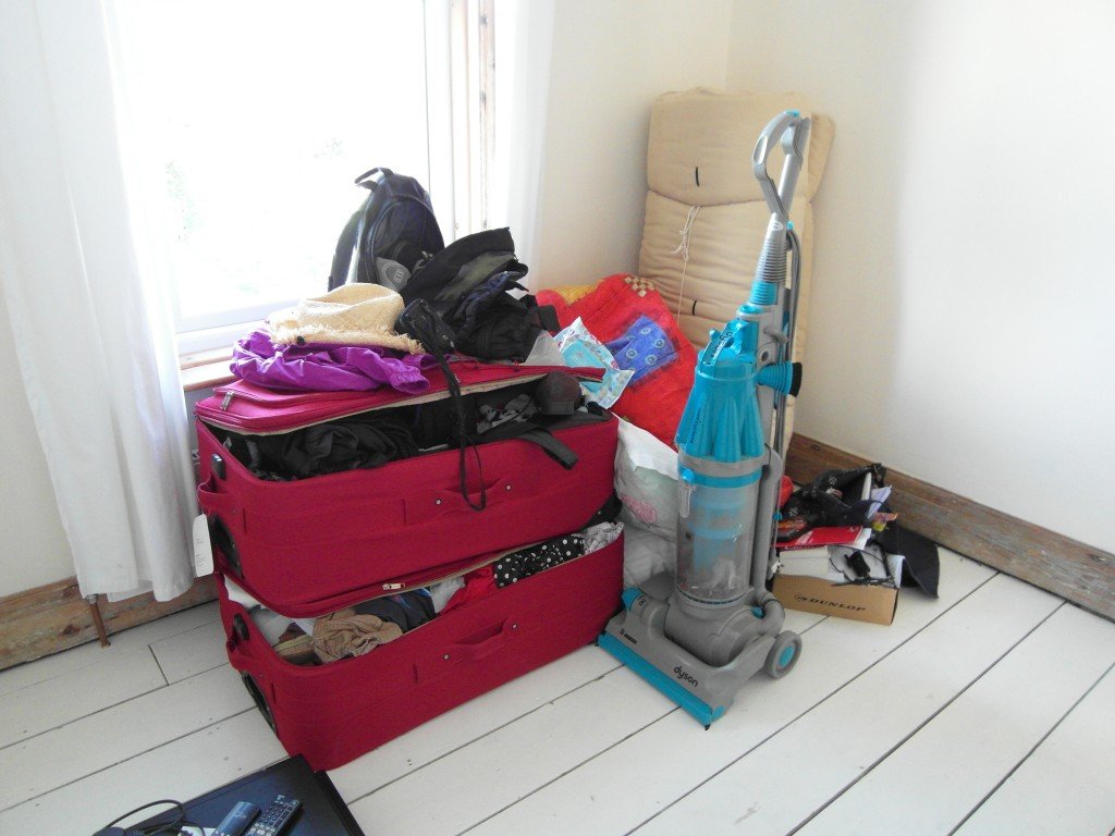 A suitcase and vacuum cleaner
