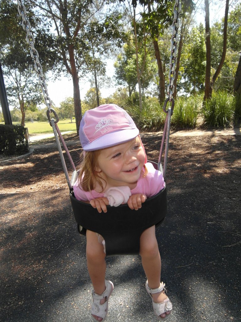 A toddler on a swing