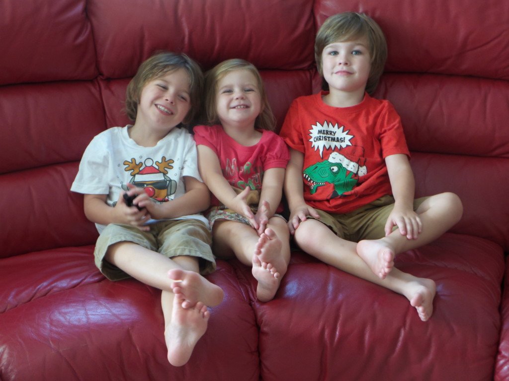 Three children on a sofa