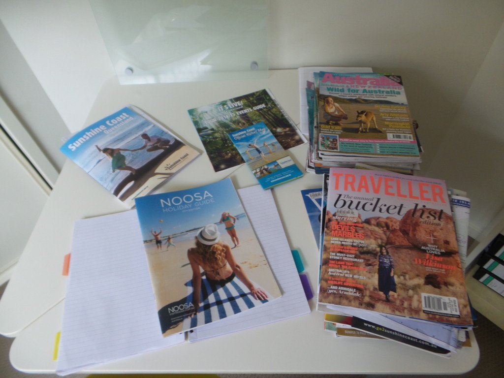A table of travel magazines and brochures